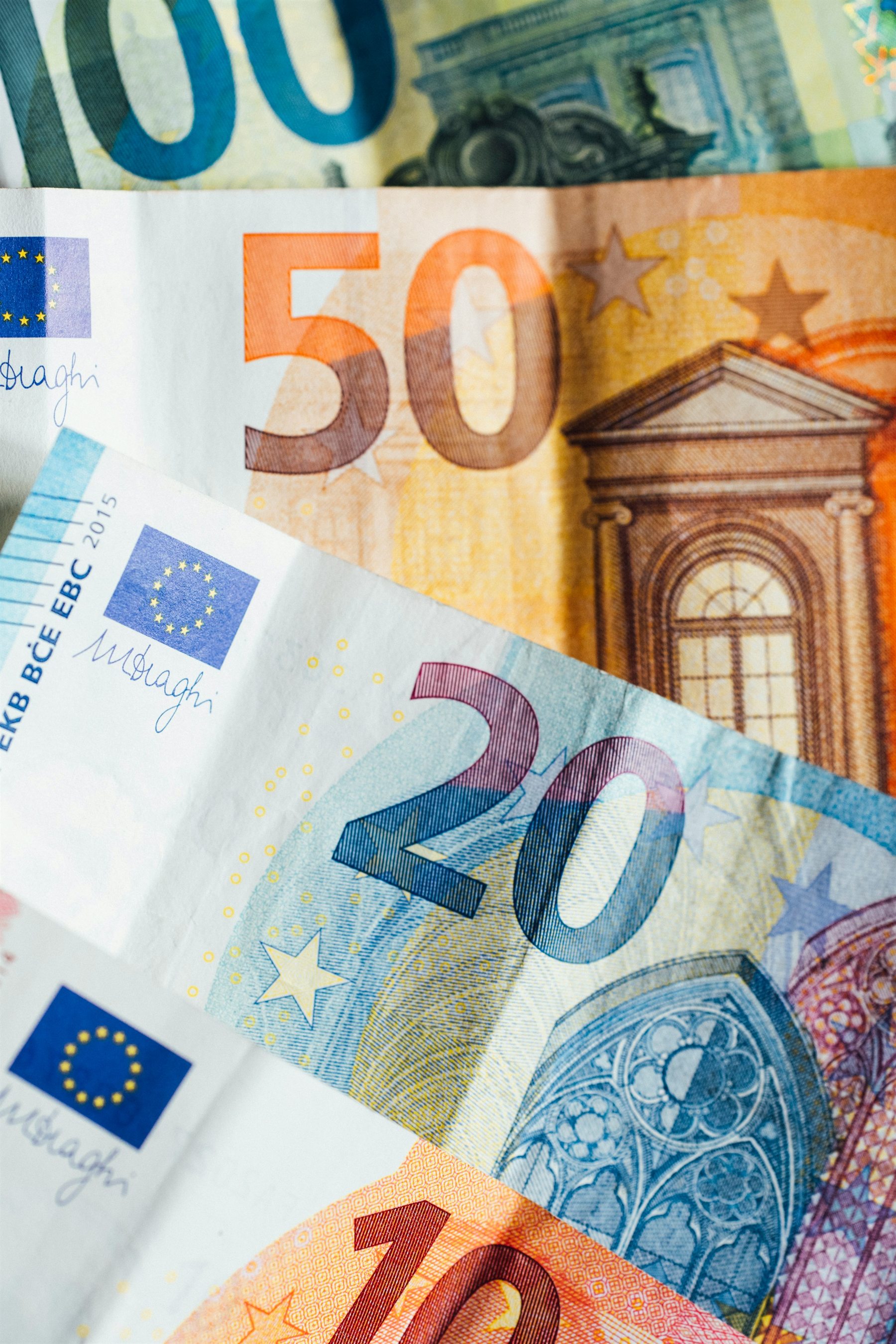 Euro banknotes arranged across a table